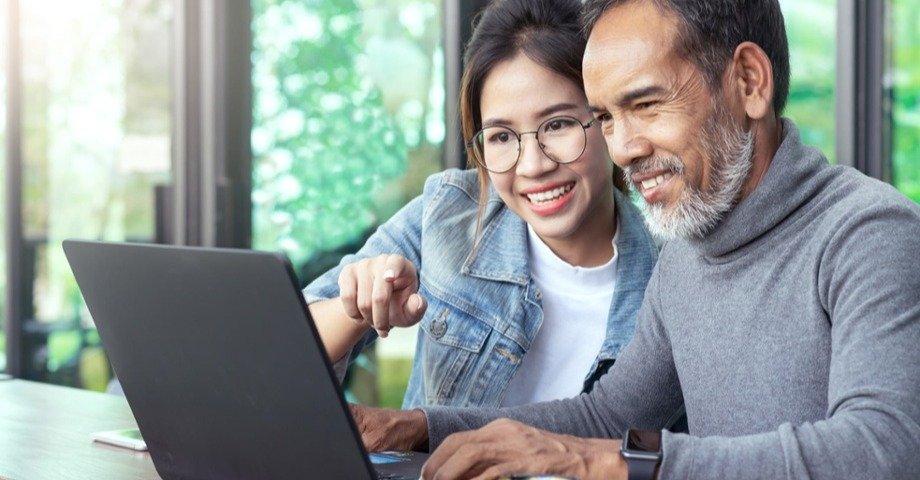 woman and man looking at laptop