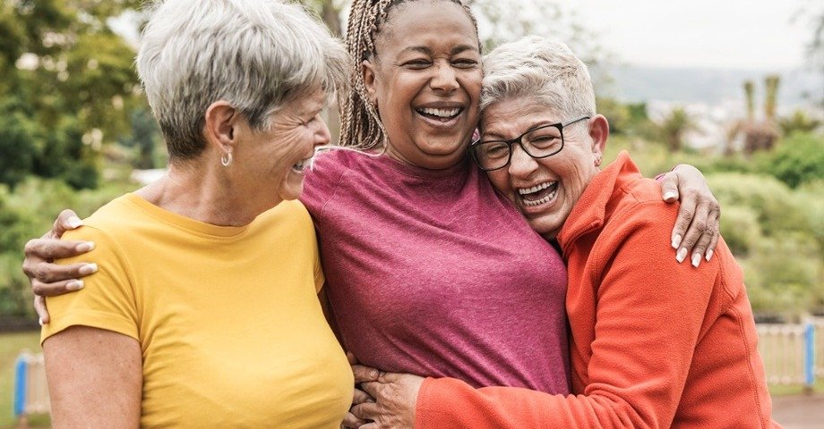 group of friends laughing and hugging