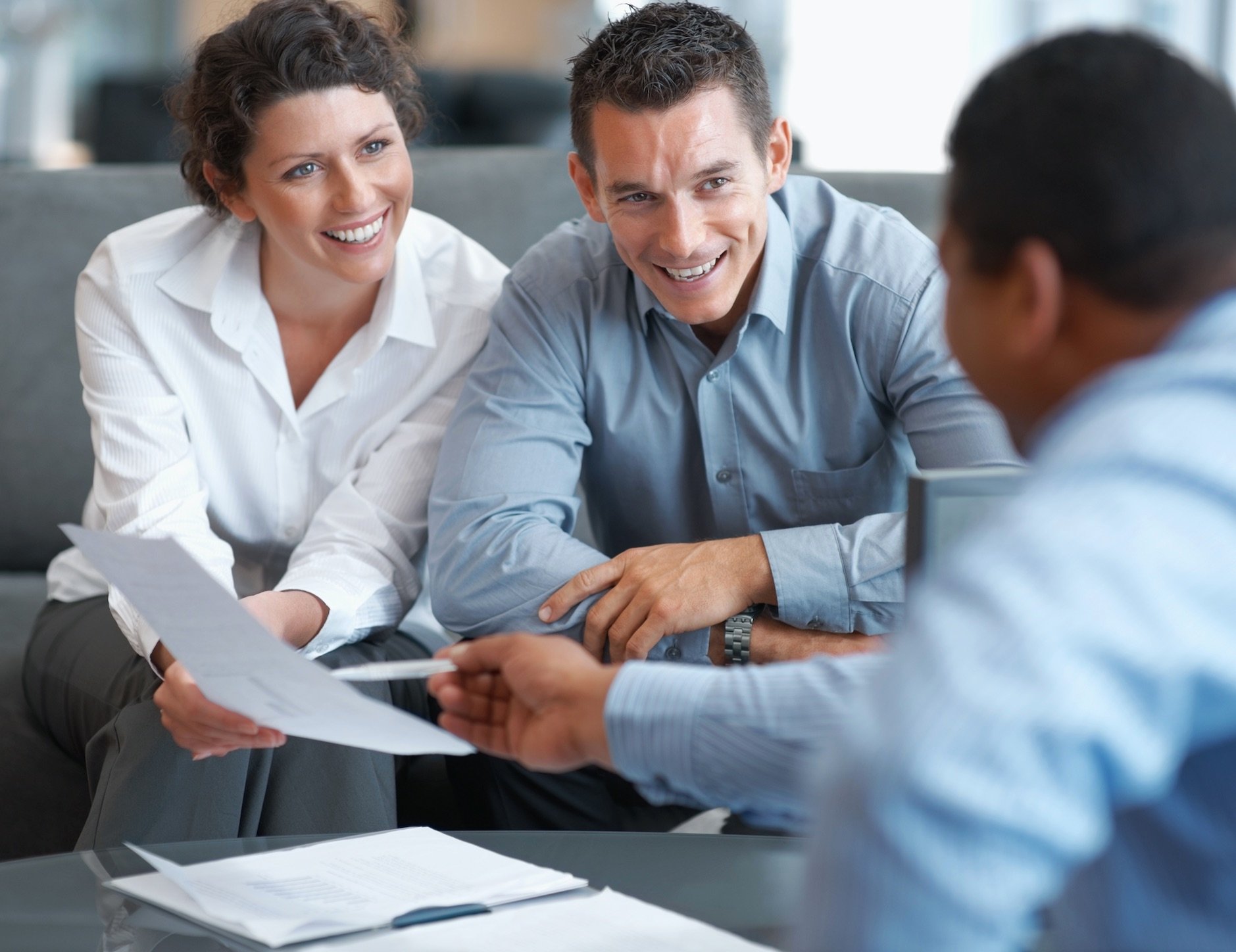 couple looking over paperwork with an advisor