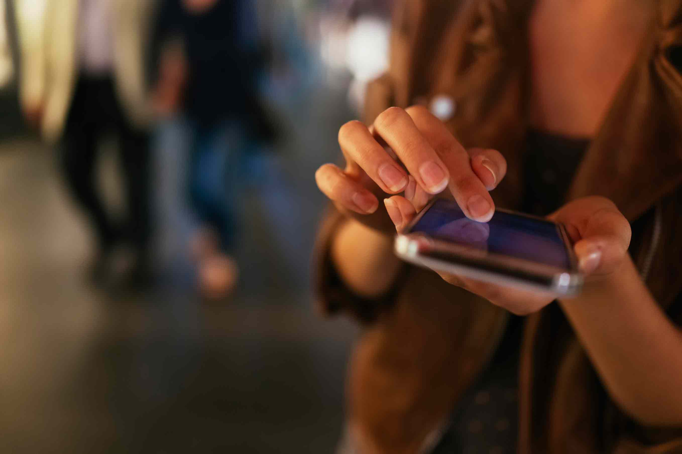 woman typing on phone